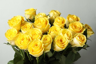 Photo of Beautiful bouquet of yellow roses on light grey background, closeup