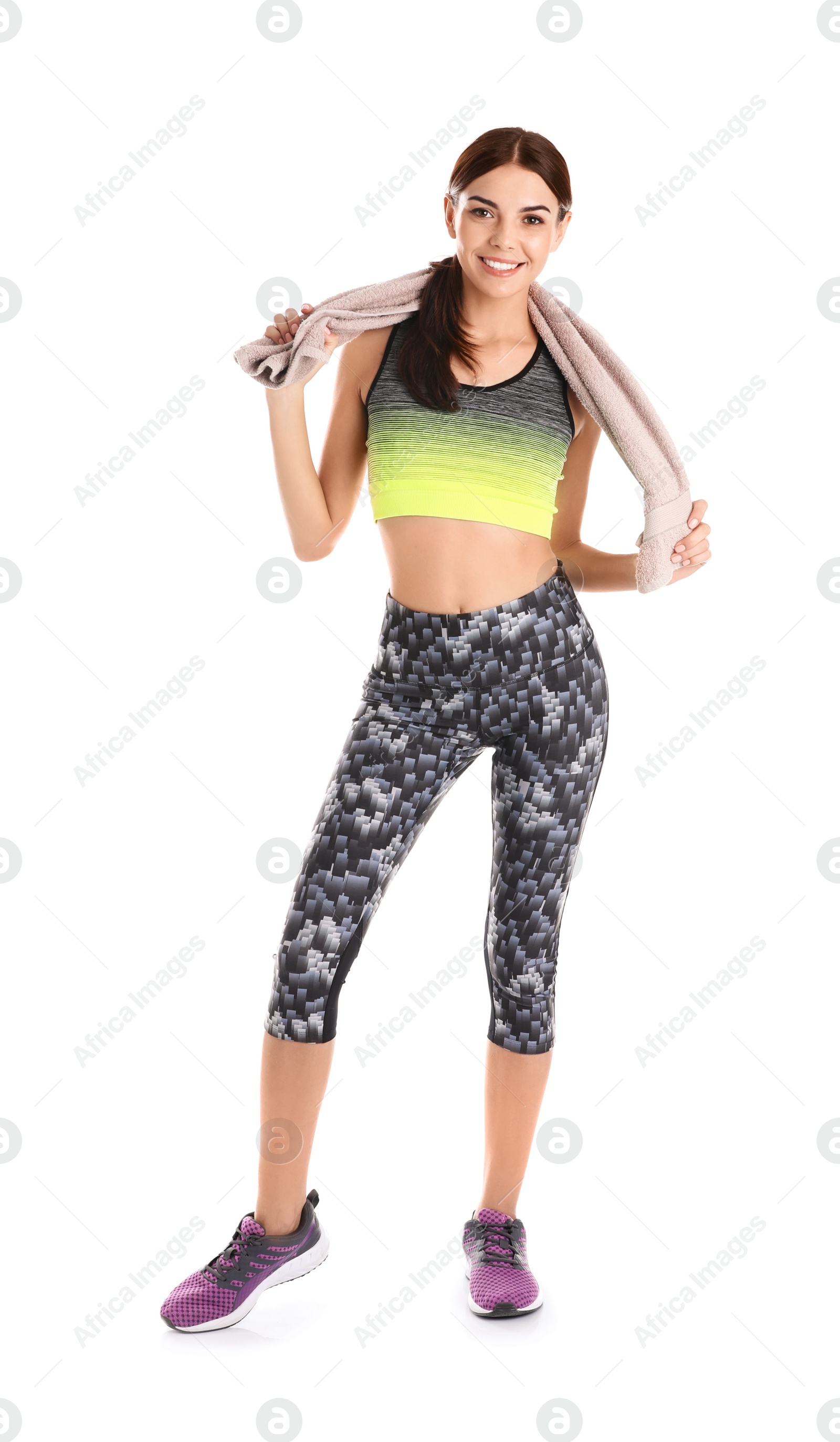 Photo of Beautiful young woman in sportswear with towel on white background