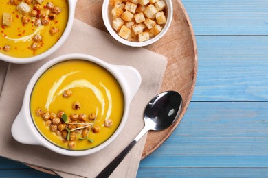 Photo of Delicious cream soup with chickpeas on light blue wooden table, top view