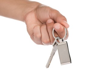 Photo of Woman holding key with metallic keychain on white background, closeup