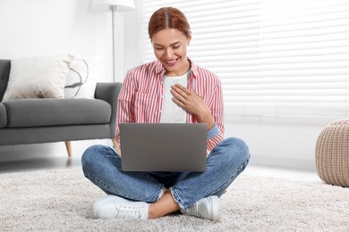 Photo of Woman having video chat via laptop at home