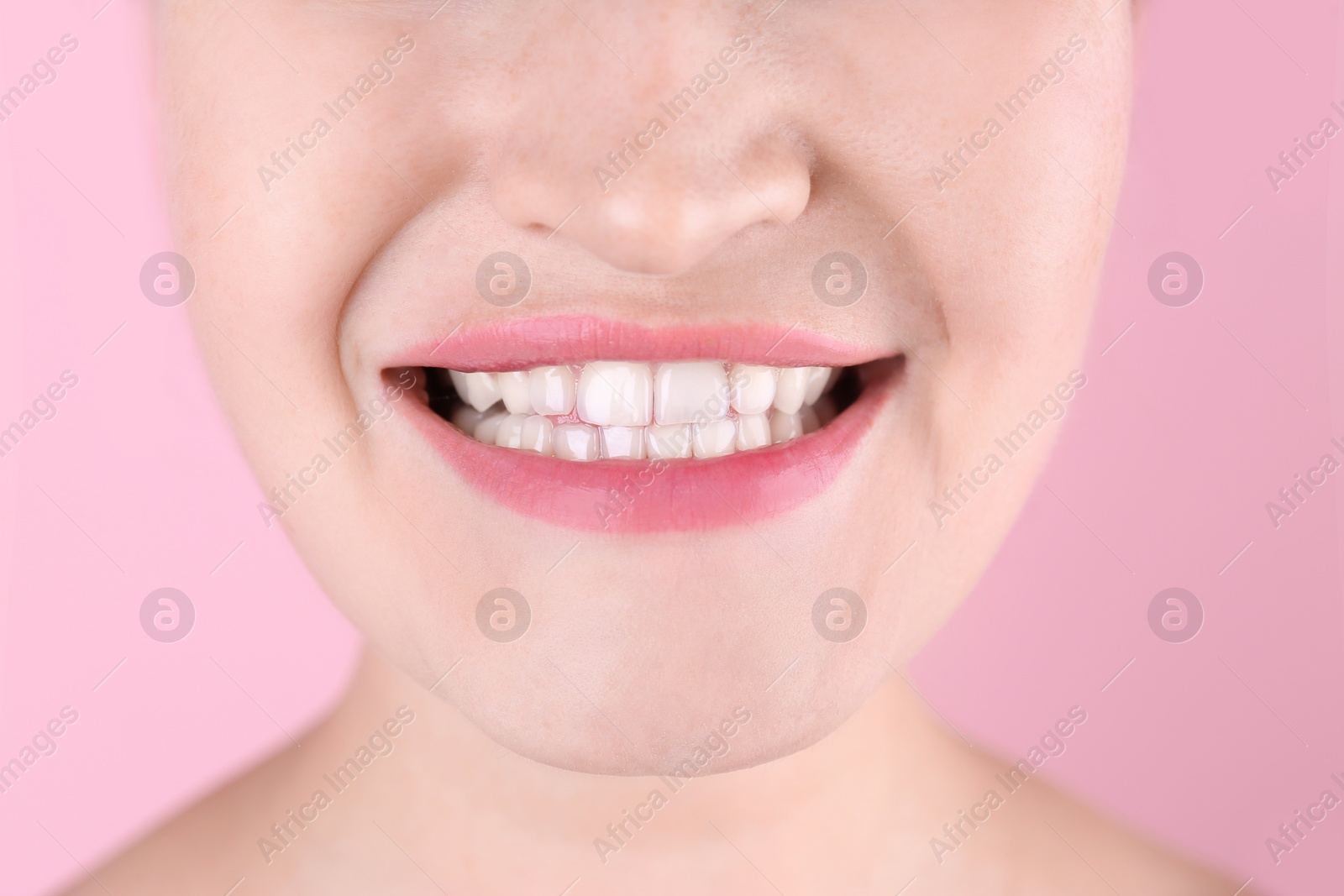 Photo of Young woman with beautiful smile on color background, closeup