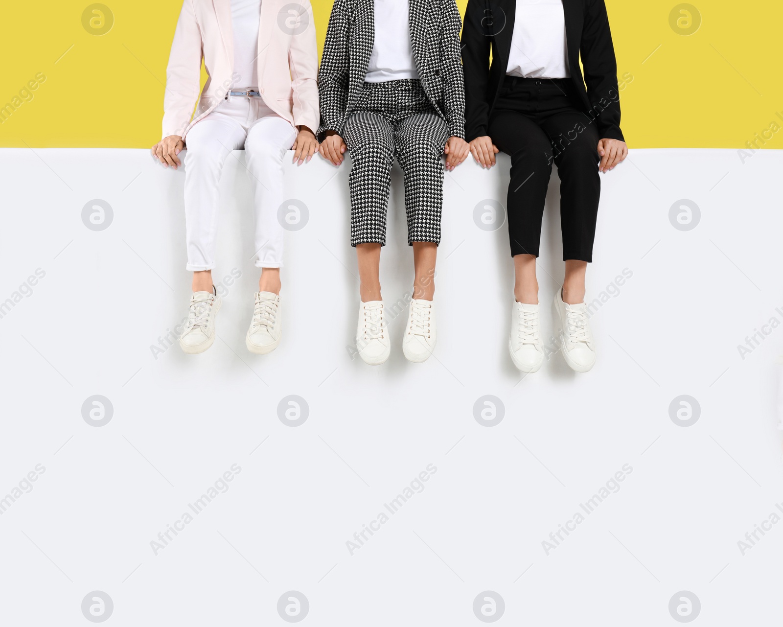 Photo of Women wearing stylish shoes on color background, closeup