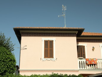 Beautiful residential building with balcony on sunny day