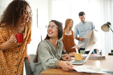 Photo of Team of professional designers working in office