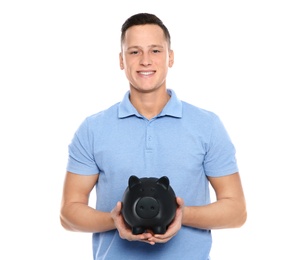 Photo of Young man with piggy bank on white background