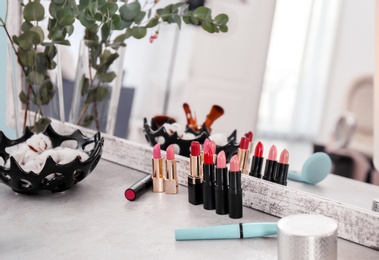 Photo of Decorative cosmetics on dressing table in makeup room