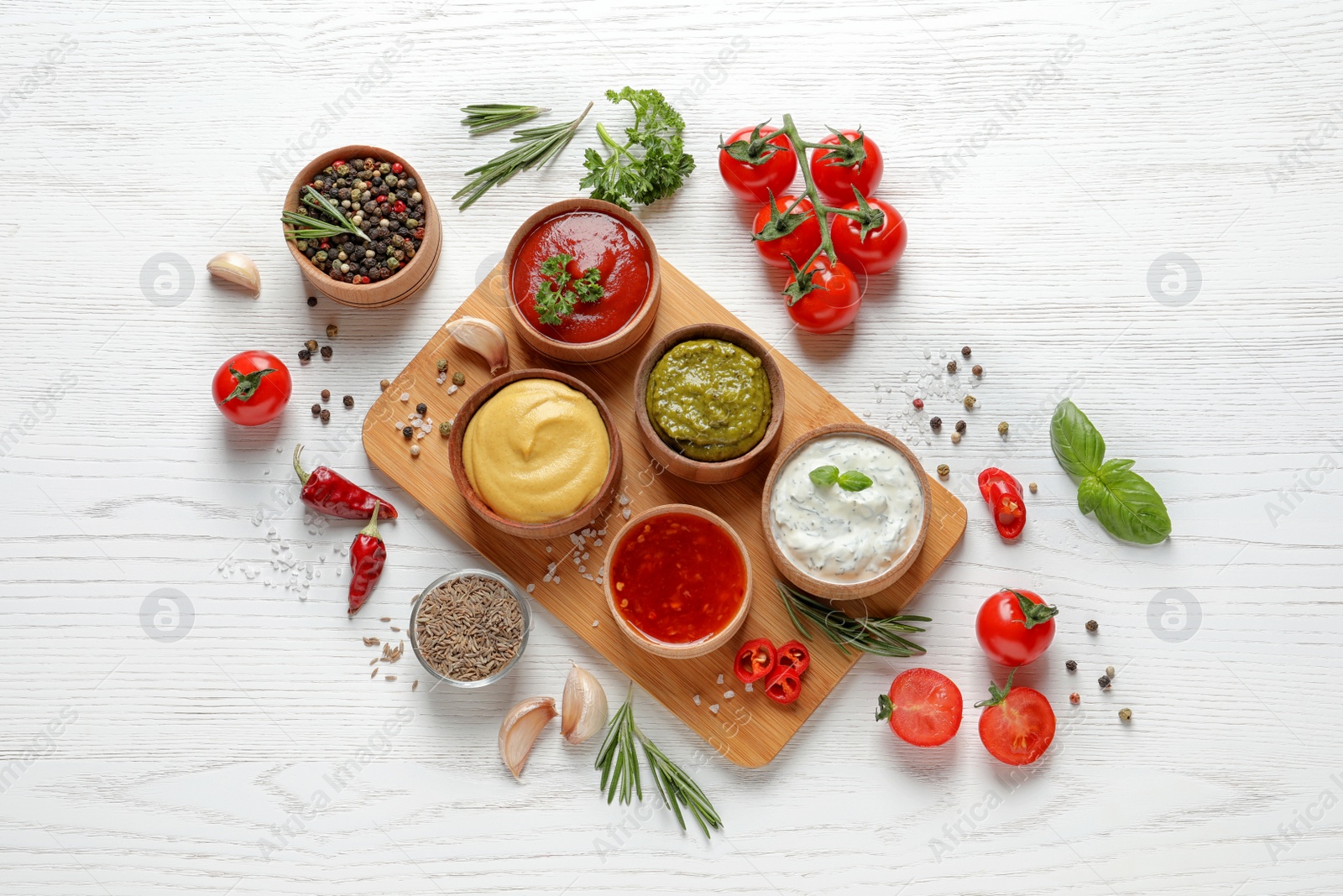 Photo of Flat lay composition with different sauces and ingredients on white wooden background
