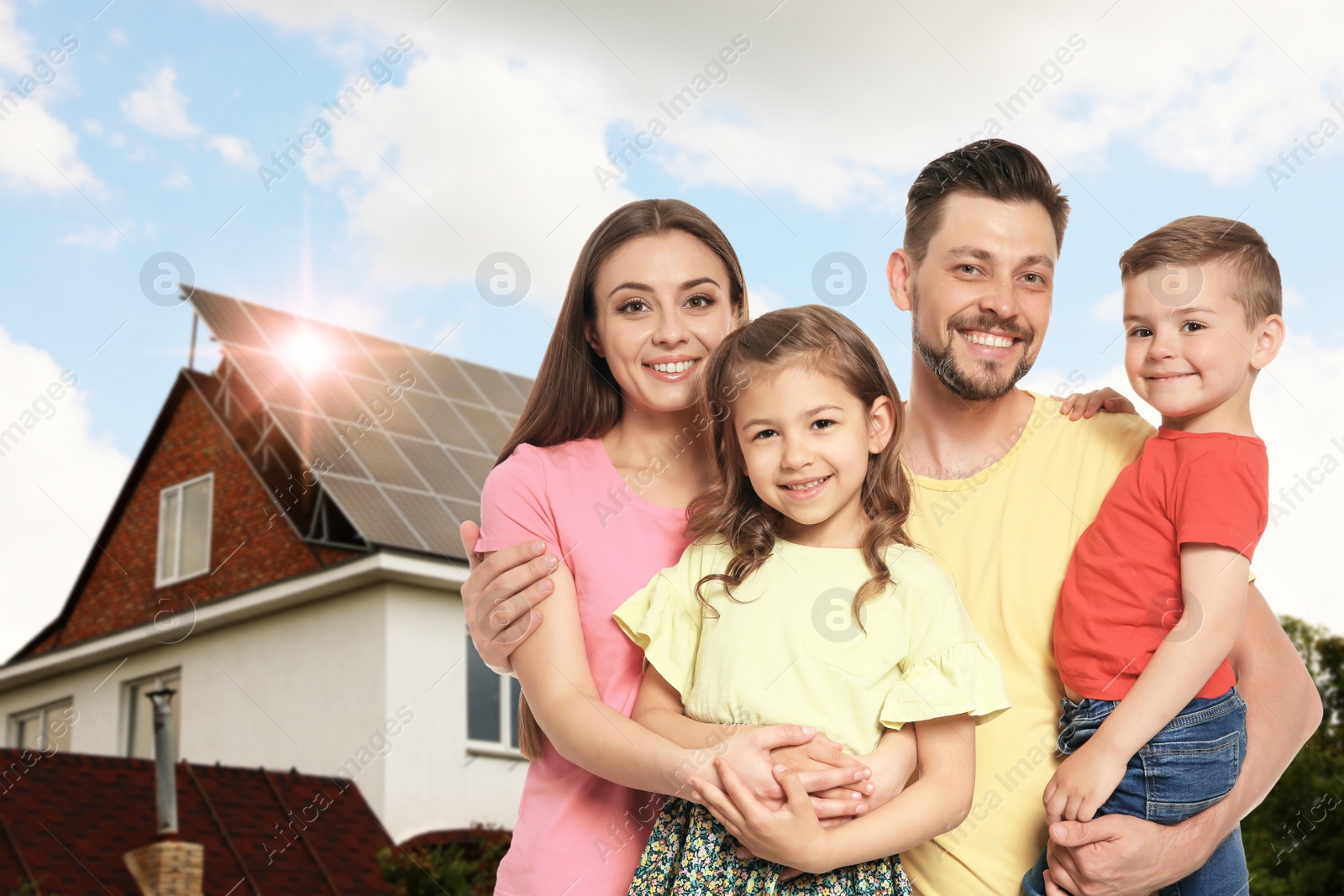 Image of Happy family near their house with solar panels. Alternative energy source