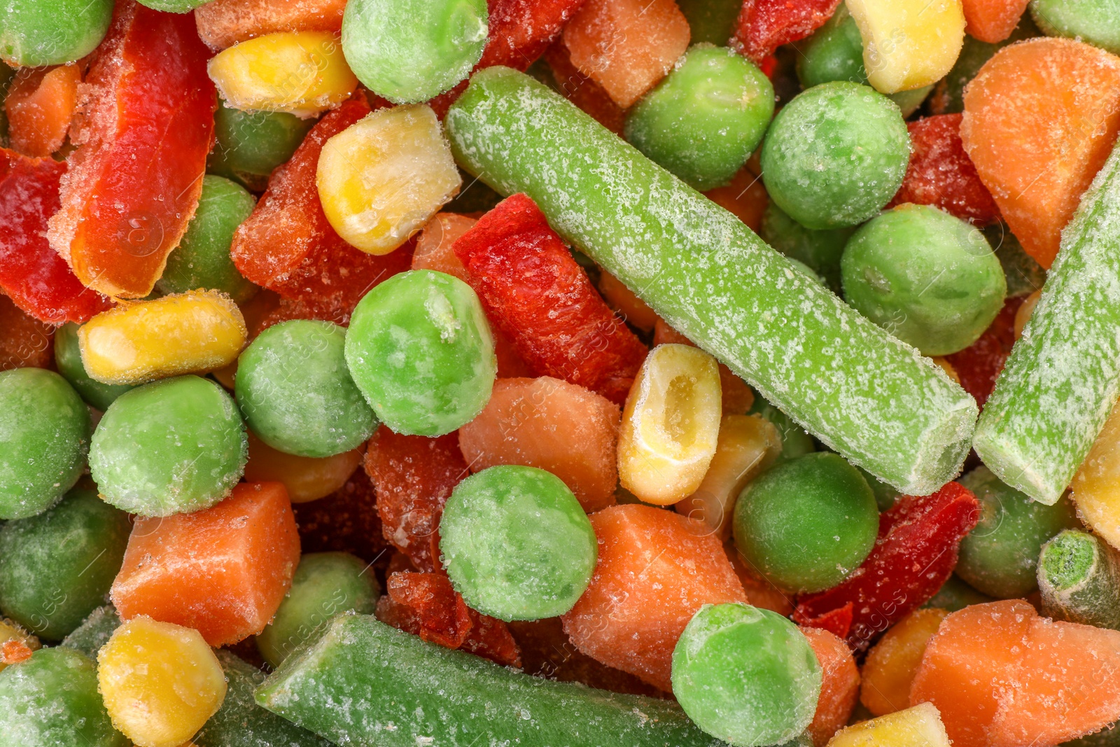 Photo of Mix of different frozen vegetables as background, top view