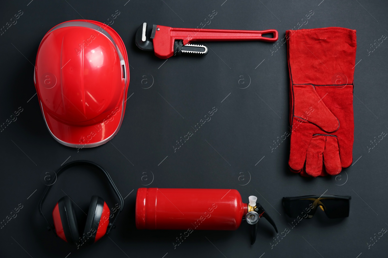 Photo of Flat lay composition with safety equipment and space for text on black background