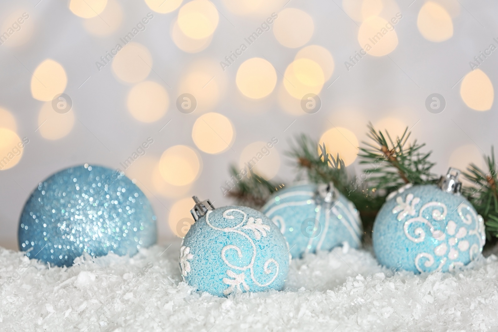 Photo of Christmas decoration on snow against blurred background