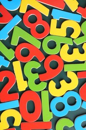 Colorful numbers on green background, top view