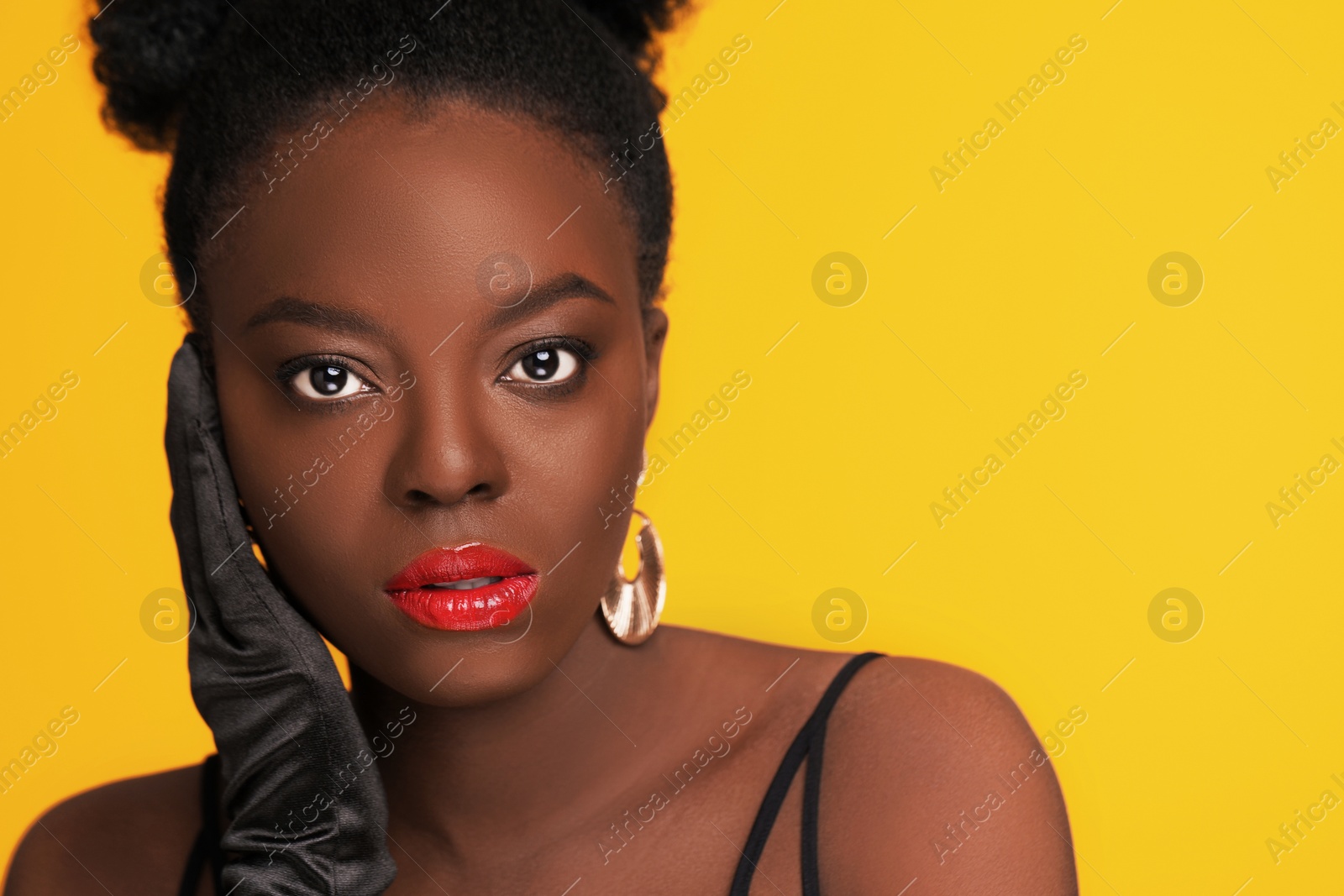 Photo of Fashionable portrait of beautiful woman on yellow background, space for text