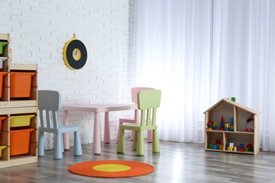 Modern child room interior with table and chairs