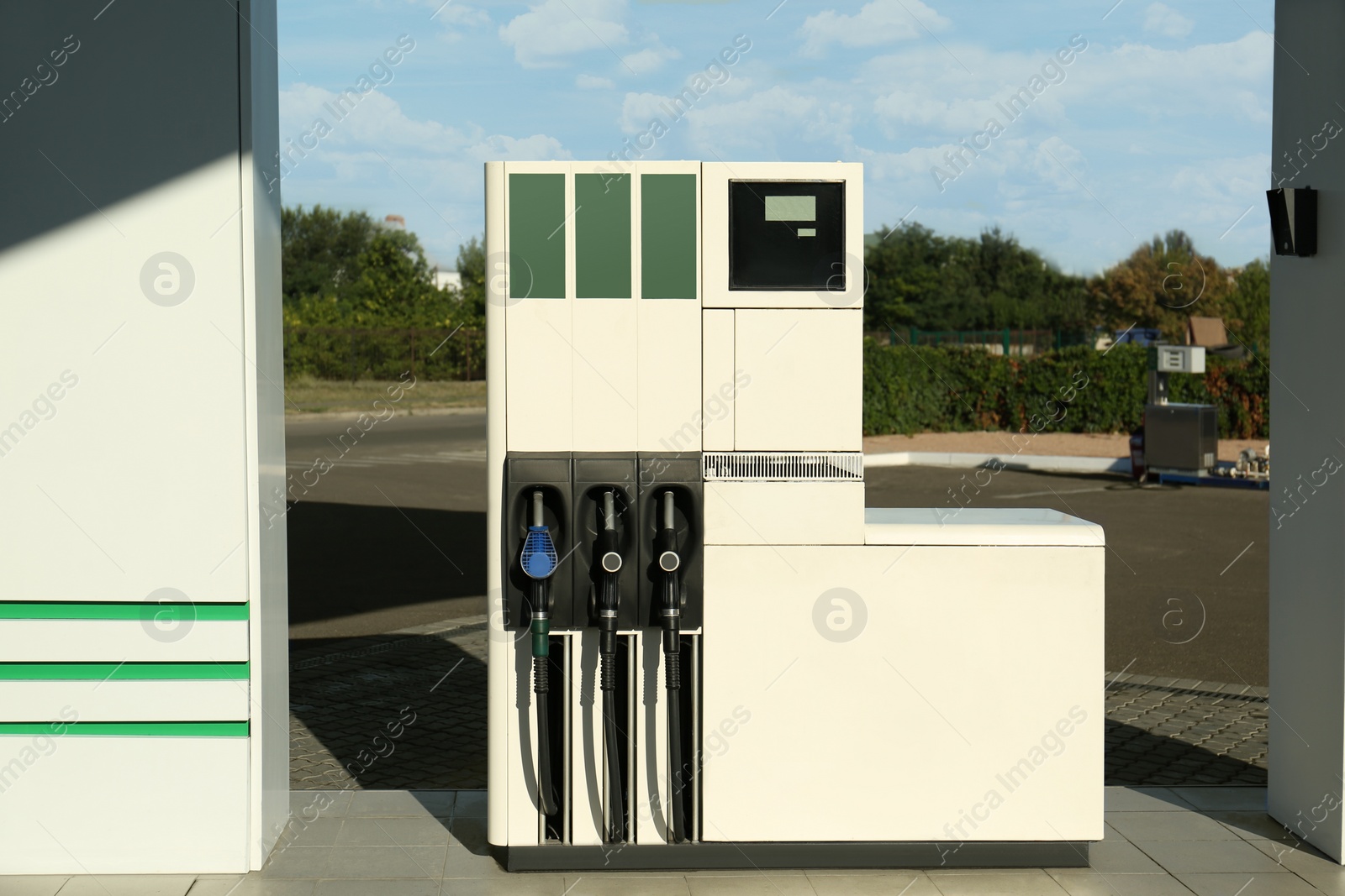 Photo of Petrol pump filling nozzles at gas station