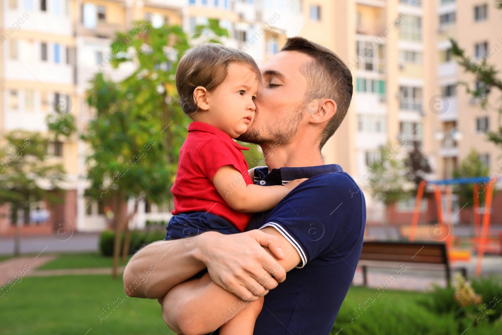 Photo of Father with adorable little baby outdoors. Happy family