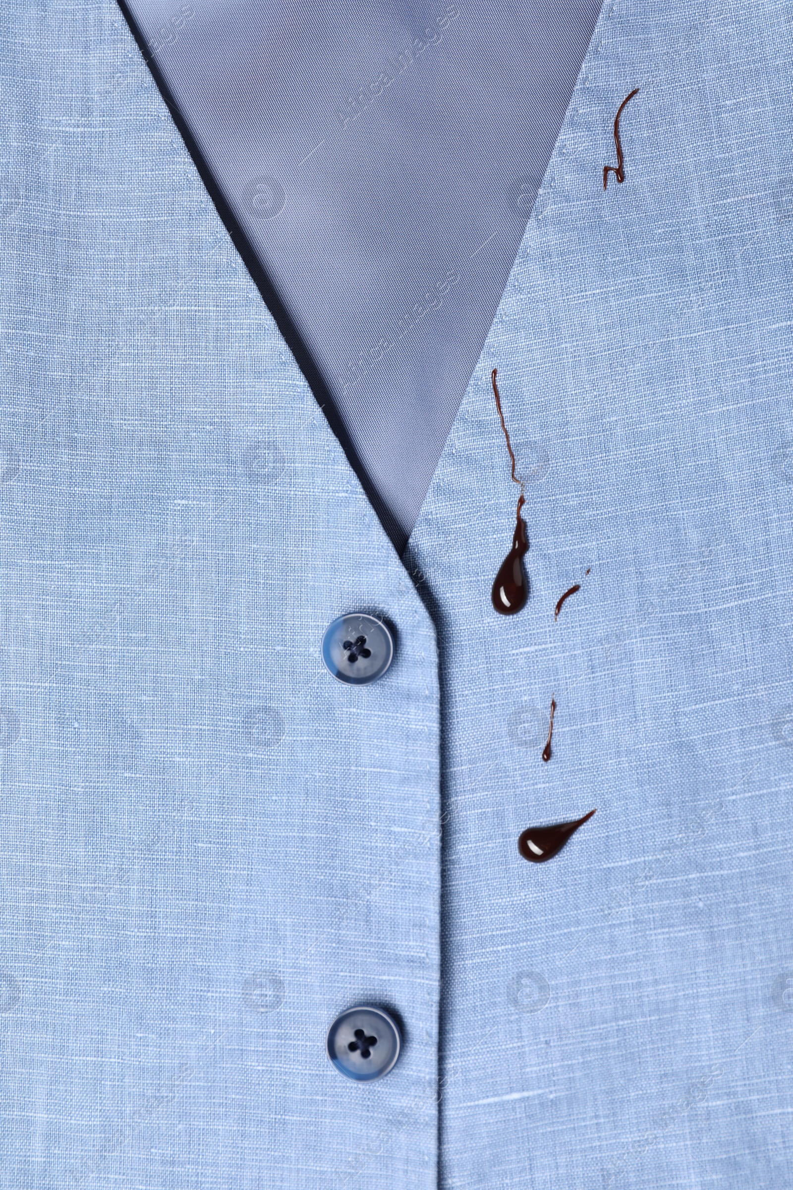 Photo of Dirty vest with drops of chocolate, top view