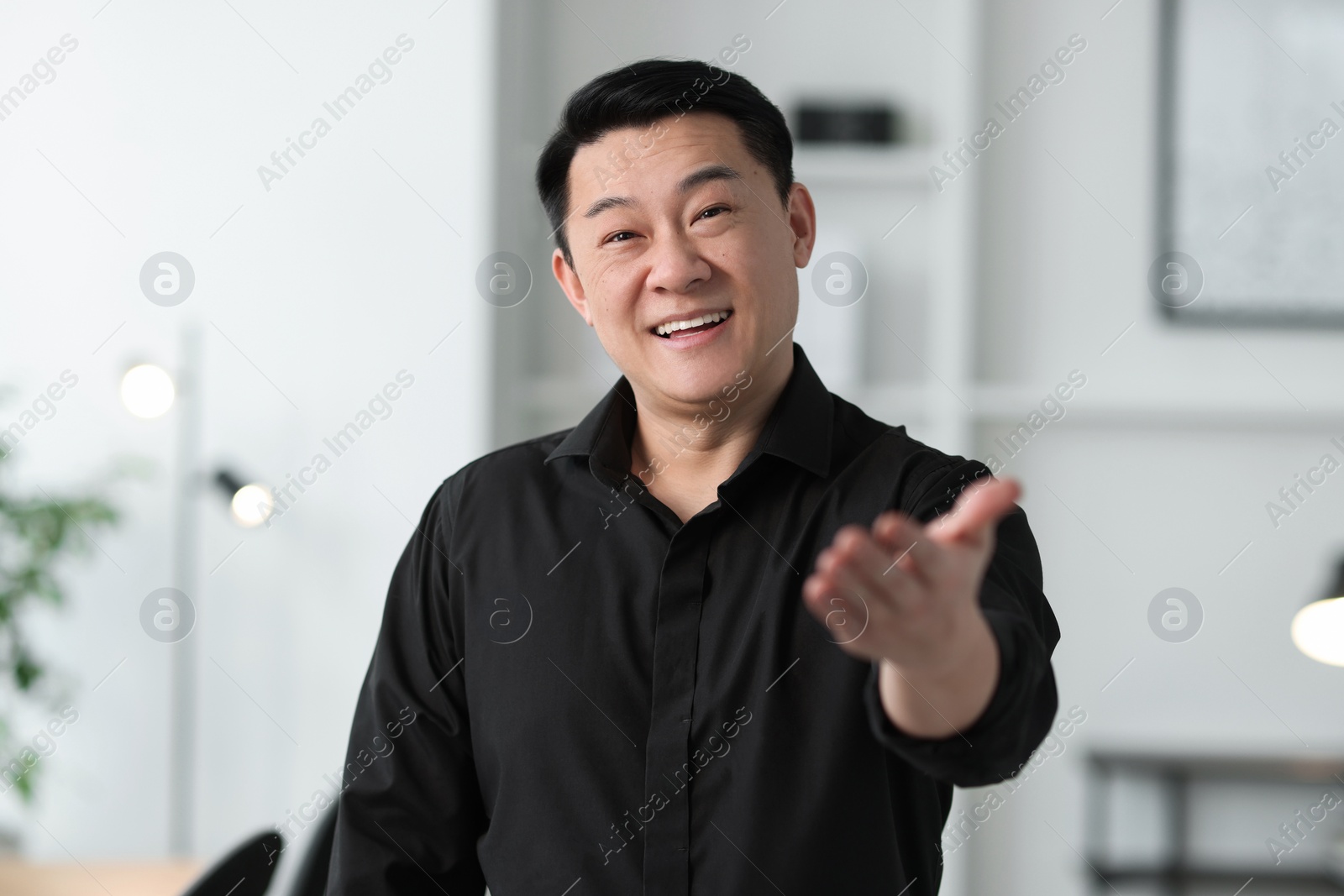 Photo of Portrait of smiling friendly businessman in office