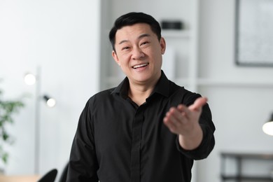 Portrait of smiling friendly businessman in office