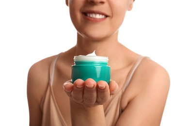 Photo of Woman holding jar of facial cream on white background, closeup