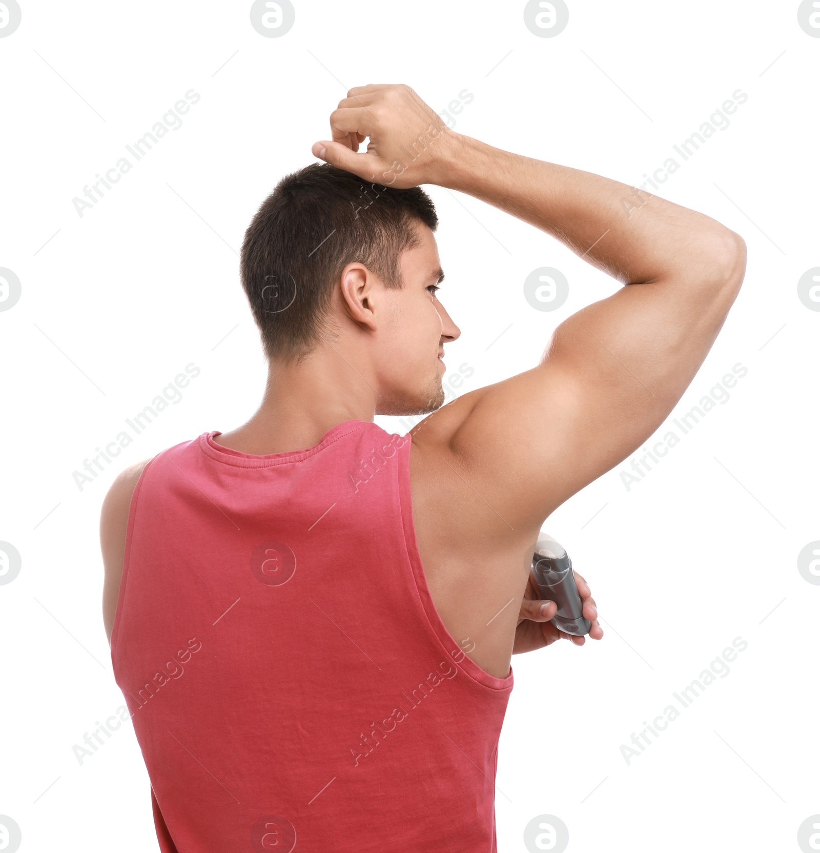 Photo of Young man applying deodorant to armpit on white background