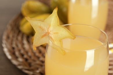 Delicious carambola juice in glass on table, closeup