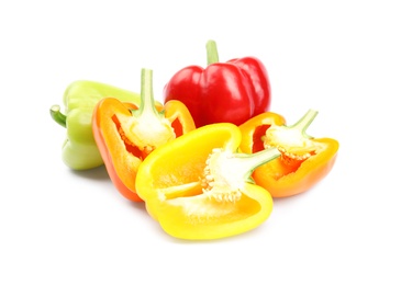 Whole and cut bell peppers on white background