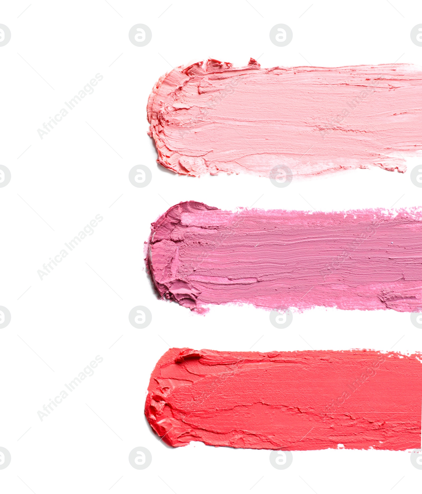 Photo of Strokes of lipstick on white background, top view