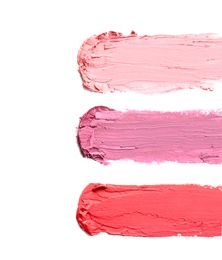 Photo of Strokes of lipstick on white background, top view