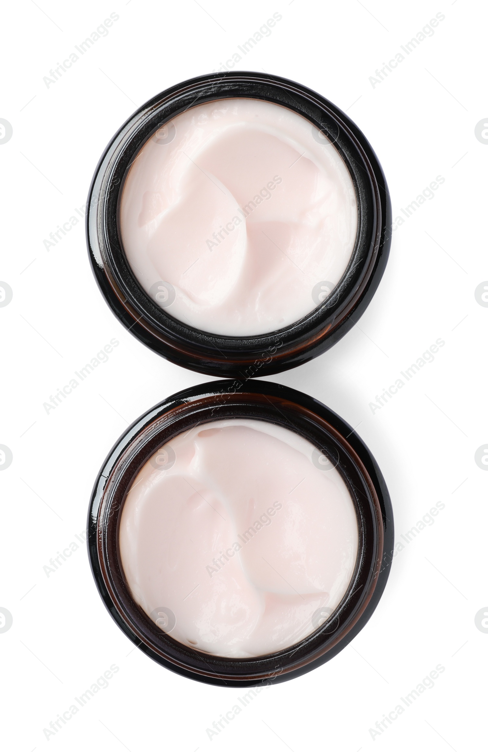 Photo of Jars of face cream isolated on white, top view