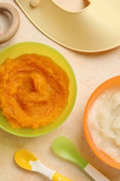 Photo of Baby food. Different tasty puree in bowls served on beige textured table, flat lay