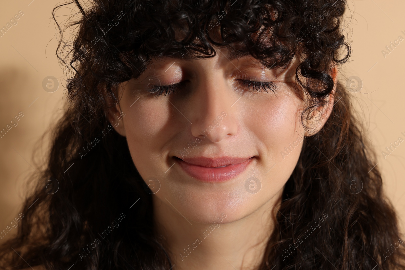 Photo of Portrait of beautiful young woman on beige background, closeup