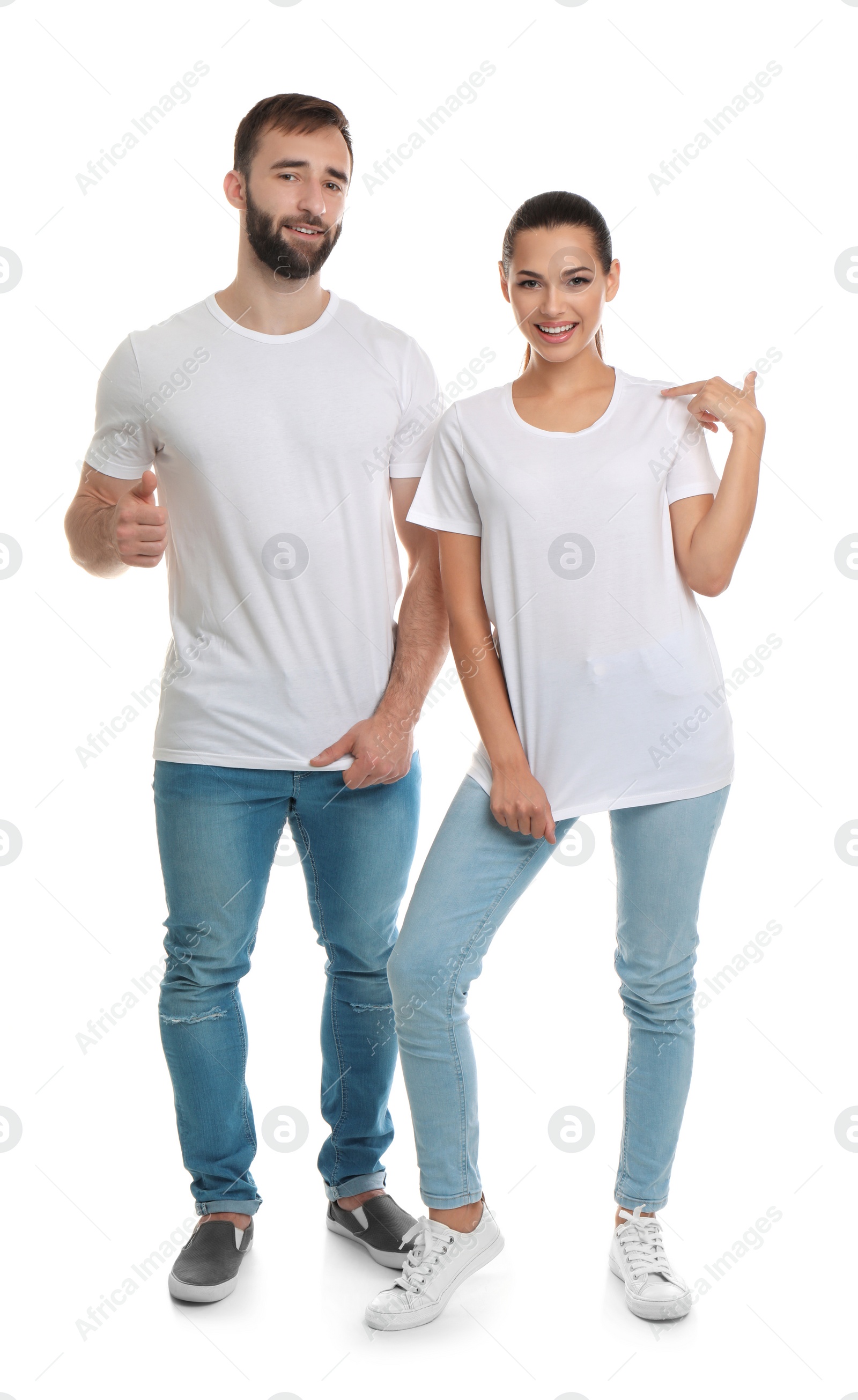 Photo of Young couple in t-shirts on white background. Mockup for design