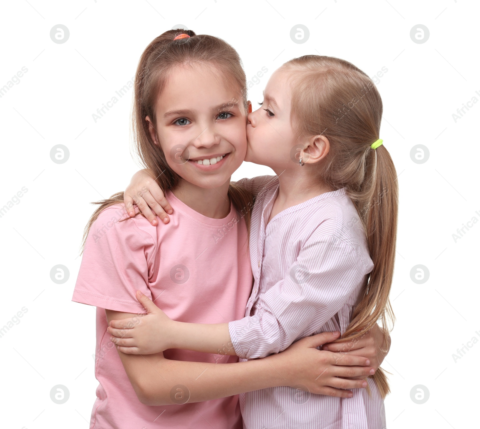 Photo of Portrait of cute little sisters on white background