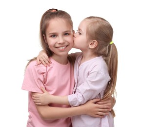 Portrait of cute little sisters on white background