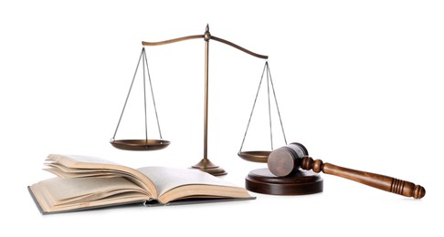 Photo of Wooden gavel, book and scales of justice on white background