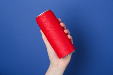 Photo of Woman with energy drink on blue background, closeup