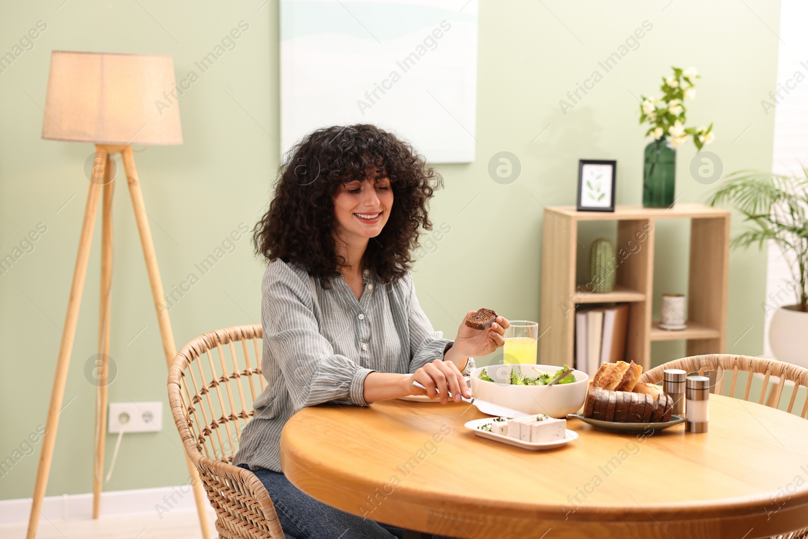 Photo of Woman having vegetarian meal at table in cafe