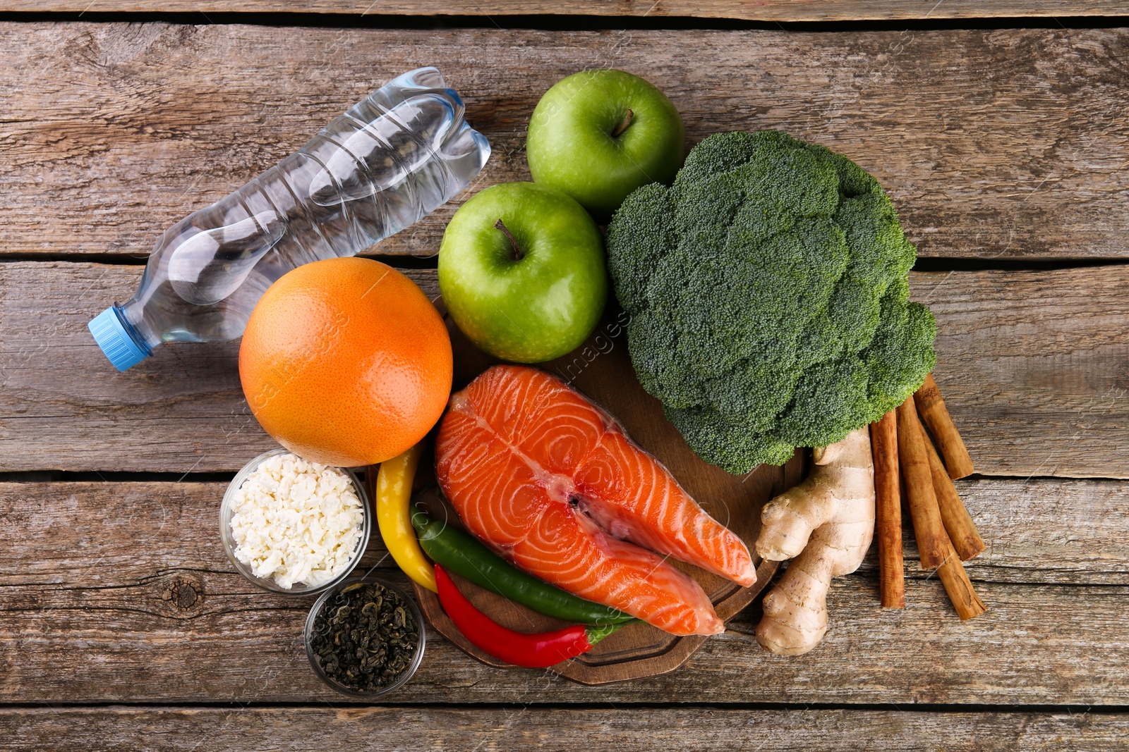 Photo of Metabolism. Different food products on wooden table, flat lay