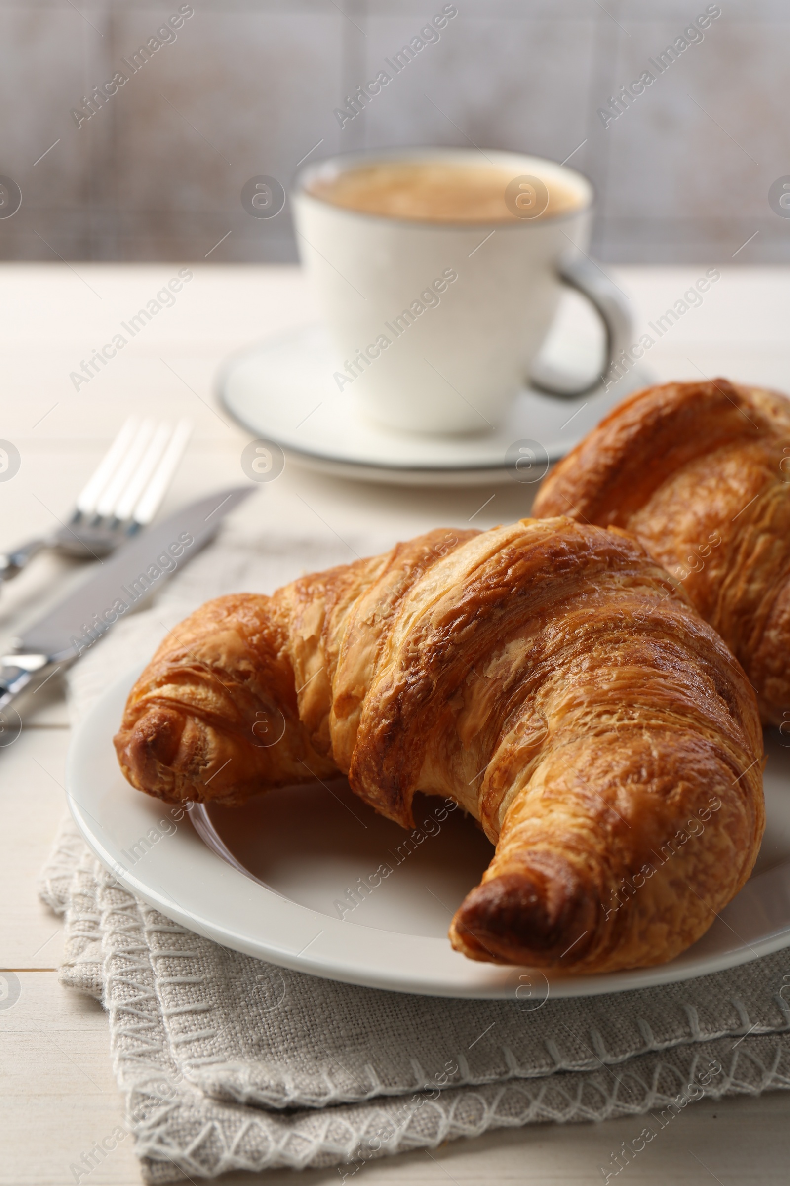 Photo of Delicious fresh croissants served on table, closeup