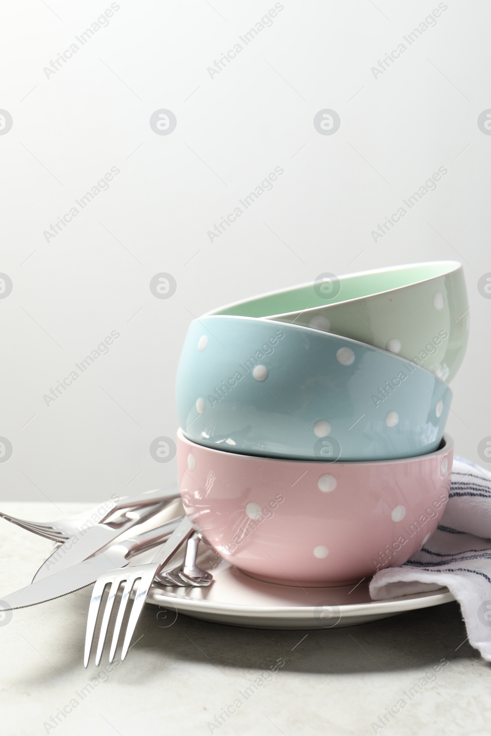 Photo of Beautiful ceramic dishware and cutlery on light grey table