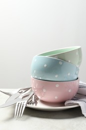 Photo of Beautiful ceramic dishware and cutlery on light grey table