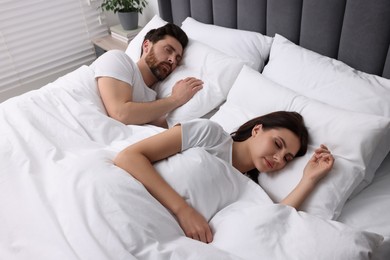 Photo of Lovely couple sleeping together in bed at home