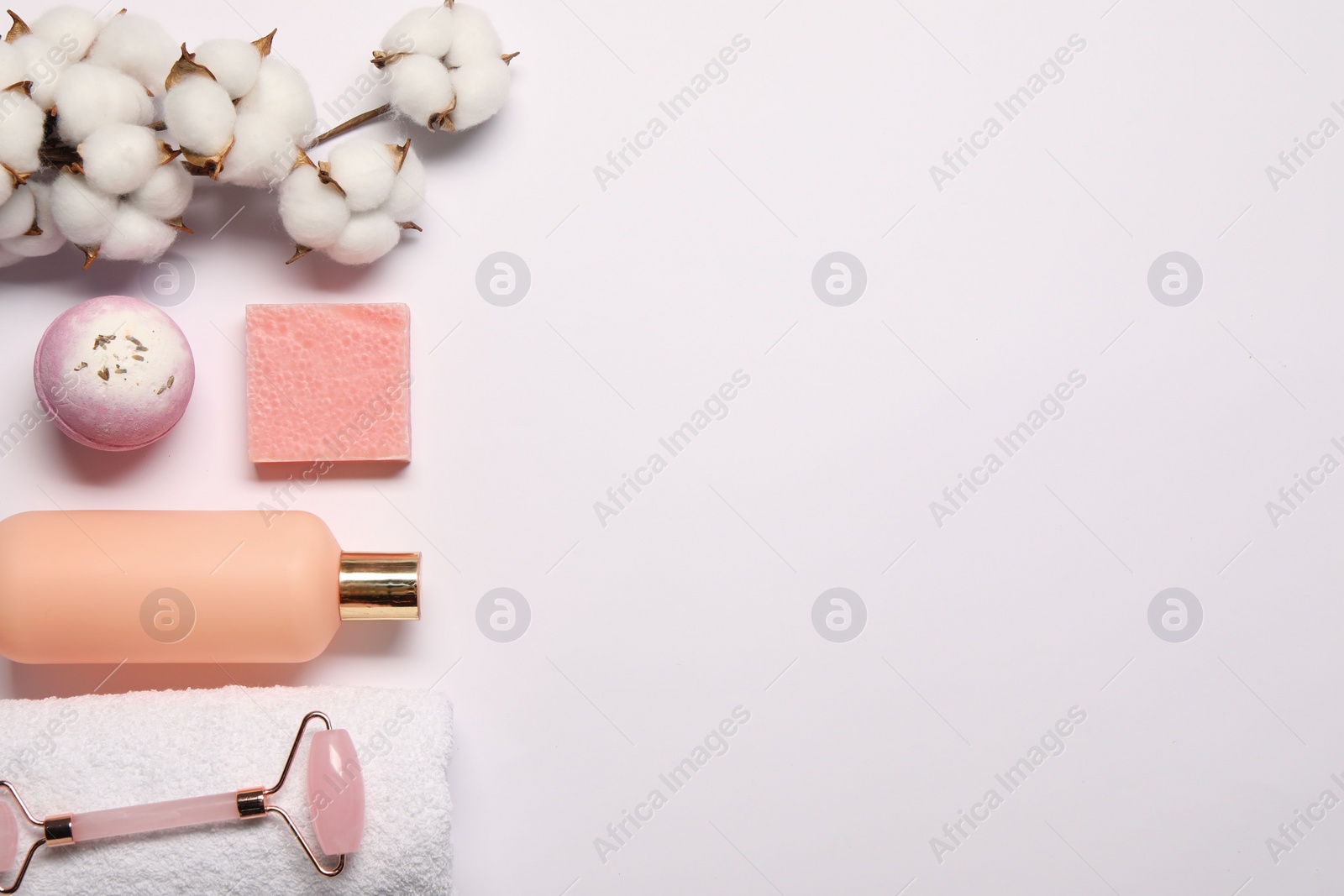 Photo of Bath accessories. Different personal care products and cotton flowers on white background, flat lay with space for text