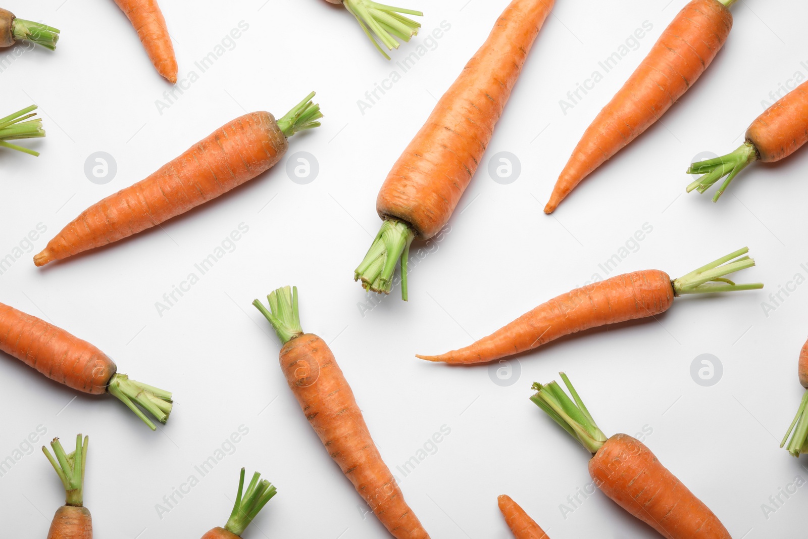 Photo of Flat lay composition with fresh carrots on color background