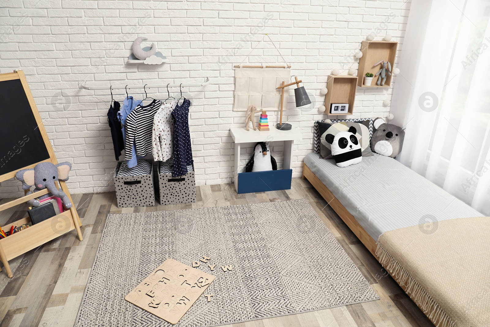 Photo of Montessori bedroom interior with floor bed and toys