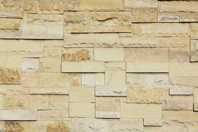 Photo of Texture of beige brick wall as background