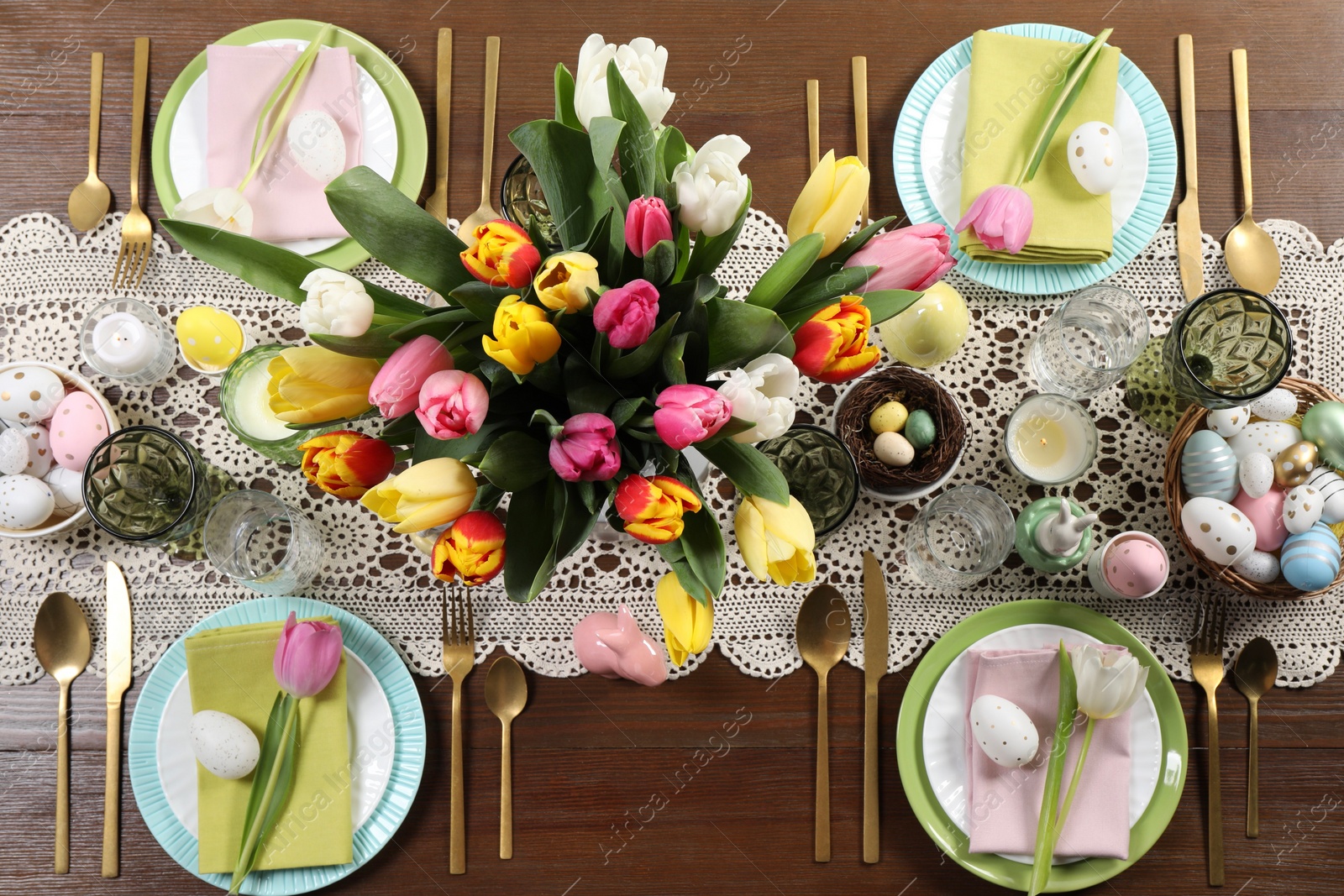 Photo of Festive table setting with beautiful flowers, flat lay. Easter celebration