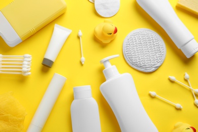 Flat lay composition with baby cosmetic products on yellow background